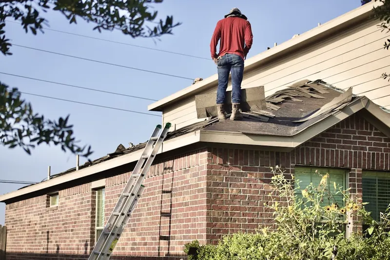 Professional roofer working on a residential roof in Commerce Square